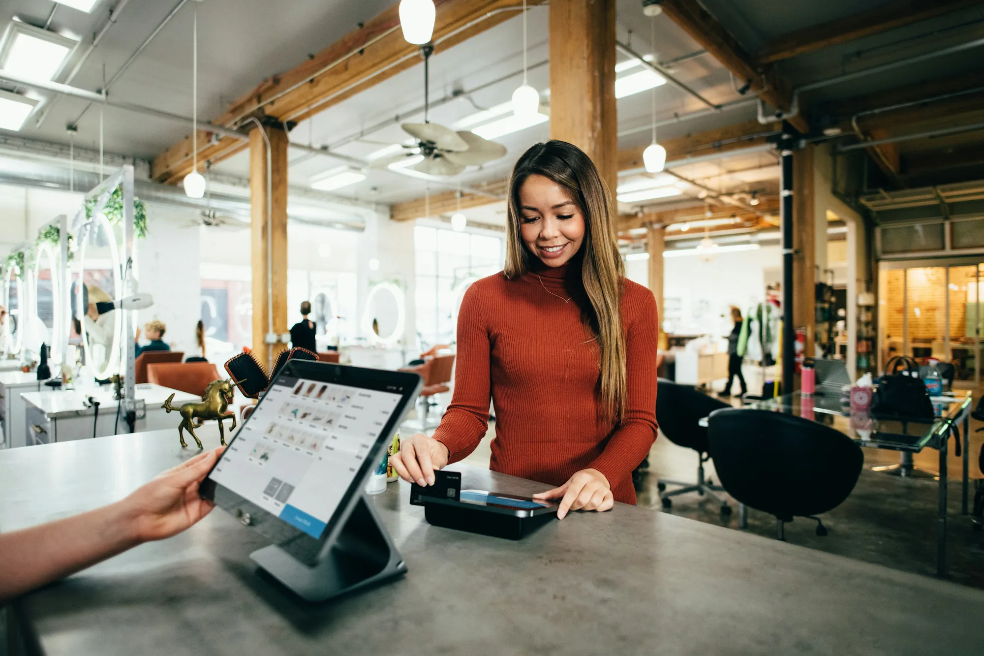 Shop owner using a tablet till at the counter
